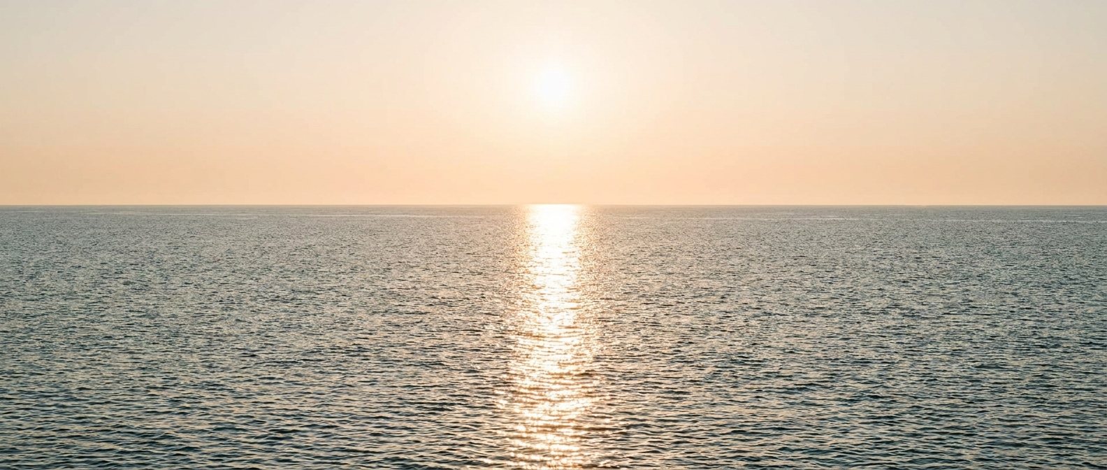 A calm ocean horizon at sunrise